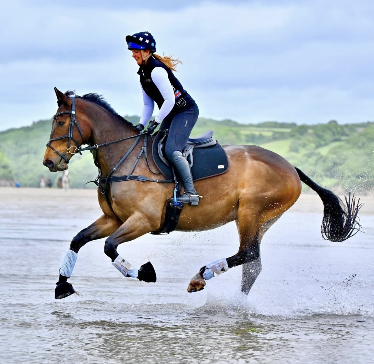 Customer galloping her horse along the beach